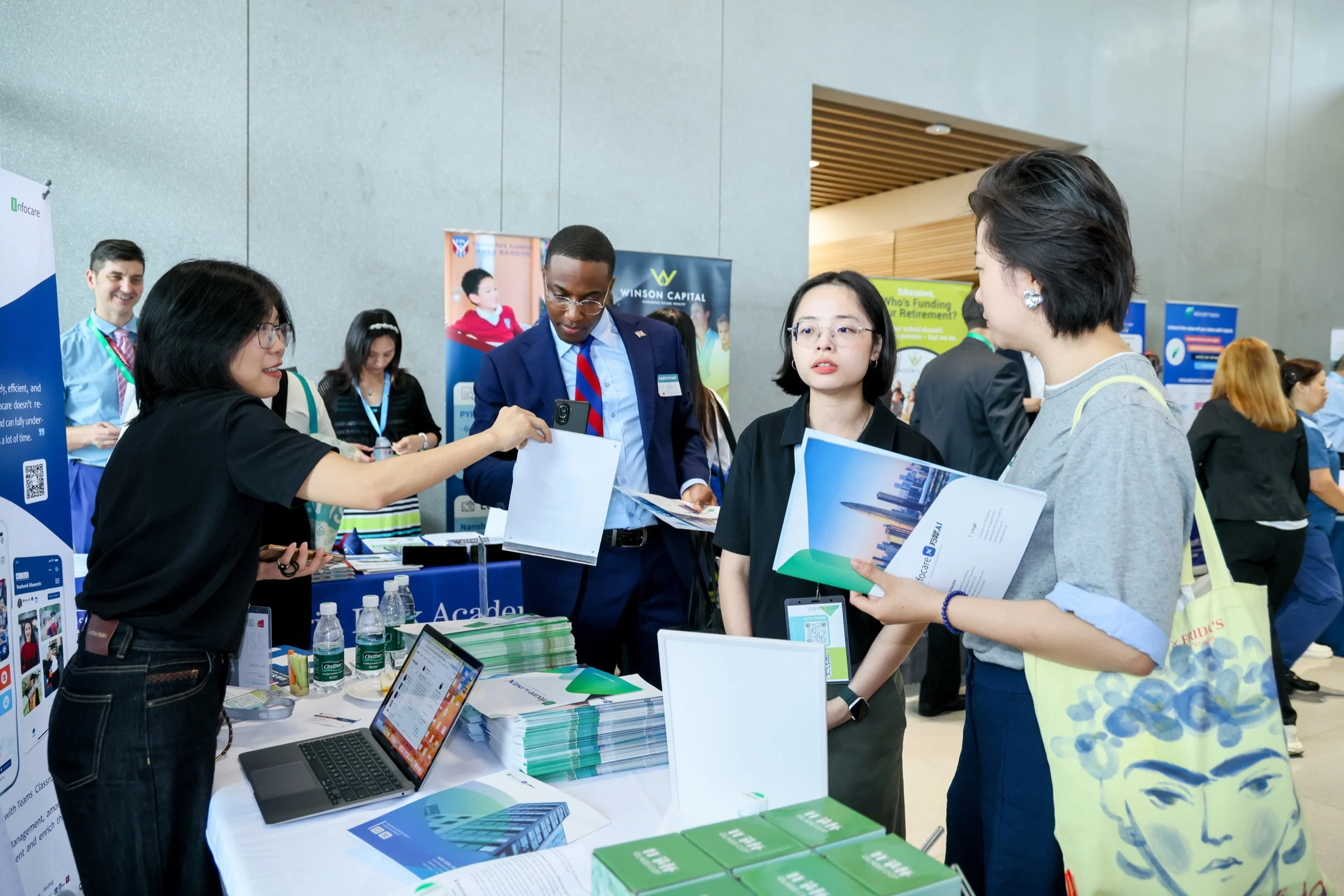Infocare team sharing school technology materials at an education event